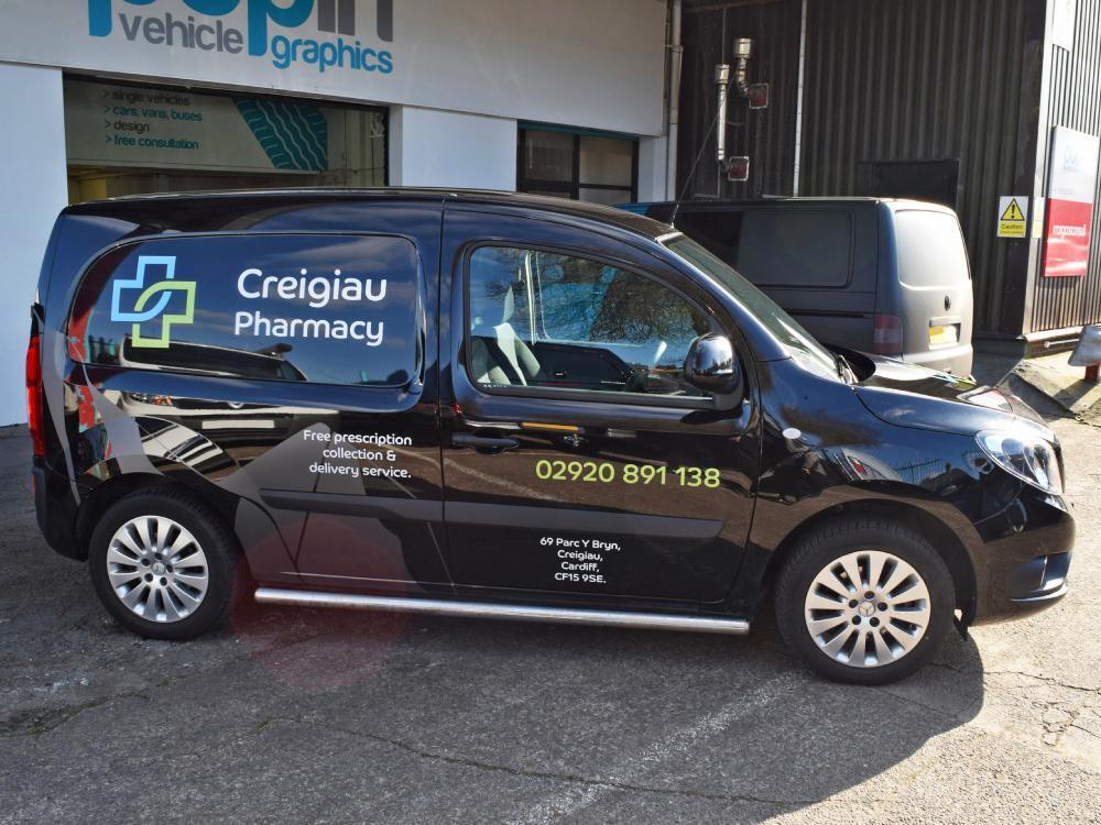 Black Mercedes Citan van with company branded vinyl graphics.
