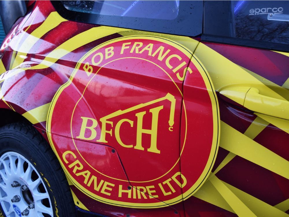 Close up of commercial wrap details on Ford Fiesta R5 company car.