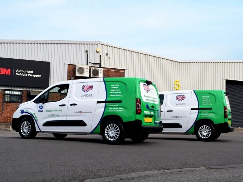 Two company electric vehicles with new liveries and vinyl graphics outside Popin wrap centre in Cardiff.