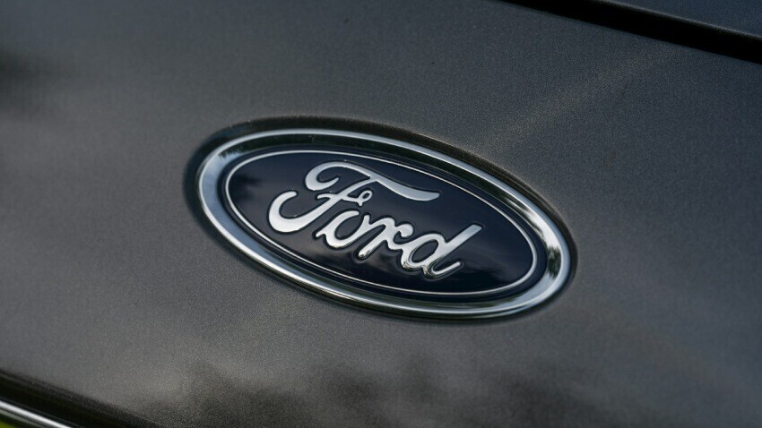 Ford badge on a grey company car.