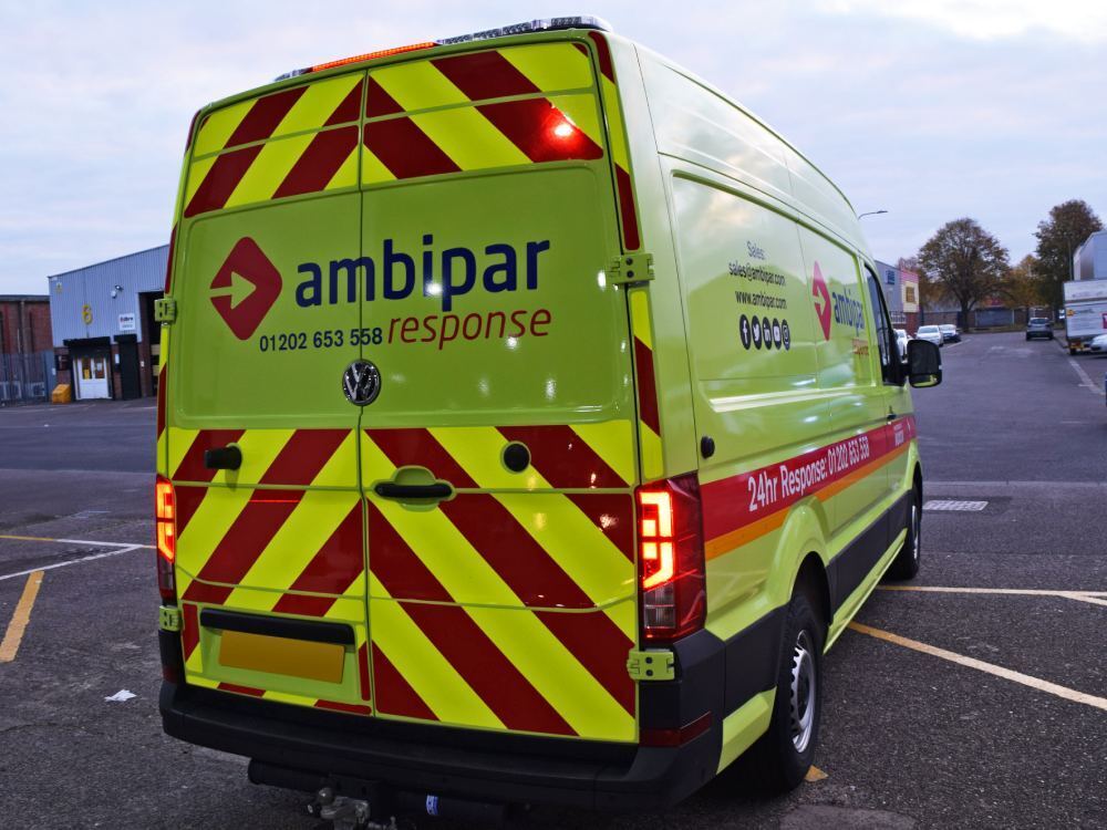 Chevron vinyl graphics and bright yellow van wrap on Ambipar Response company Volkswagen Crafter.
