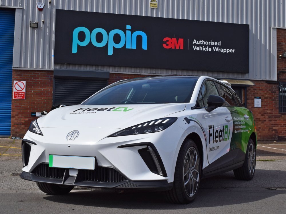 Company MG4 Trophy EV with new branded vehicle wrap and vinyl graphics outside Popin in Cardiff.