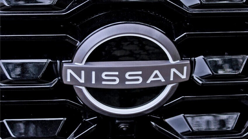 Nissan vehicle badge on company car front grille.