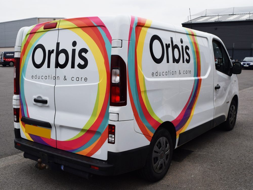 Partial vehicle wrap on a white company Fiat Talento van.