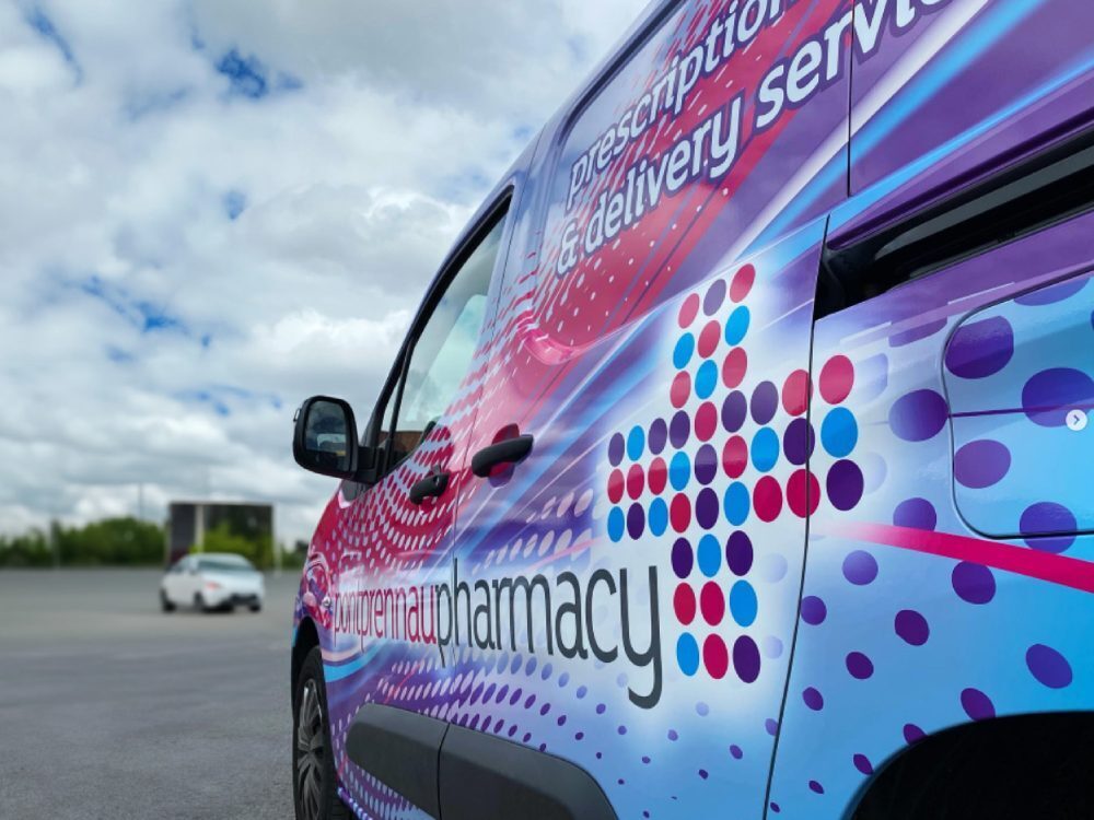 Close up of colourful vehicle wrap on company Peugeot Partner van.