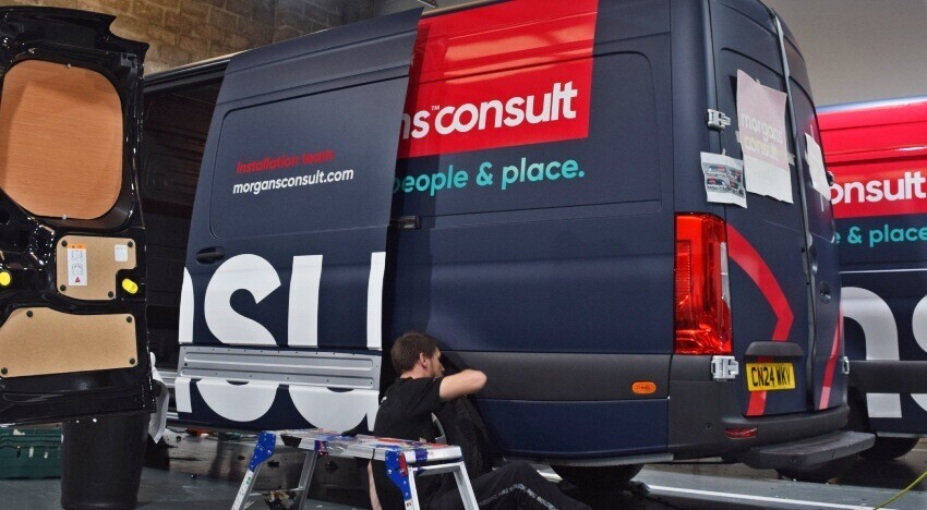Business branded van wrap being installed on a Mercedes Sprinter at Popin in Cardiff.