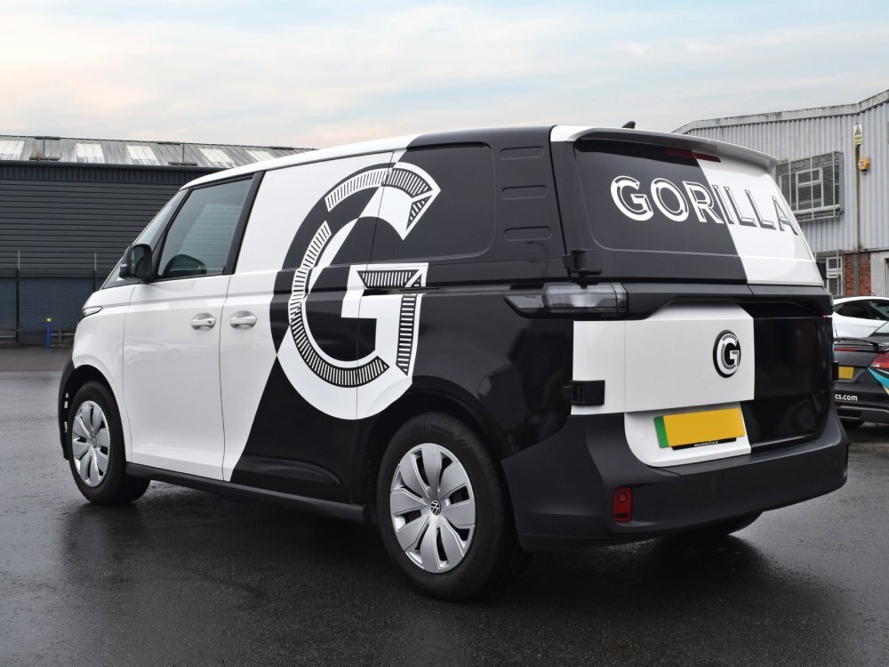 Black and white company branded van wrap on Volkswagen ID. Buzz.