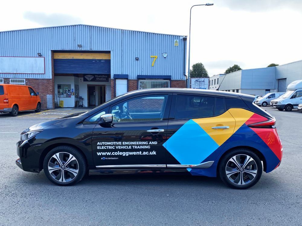 Rear partial wrap and vinyl graphics on Nissan Leaf company car.