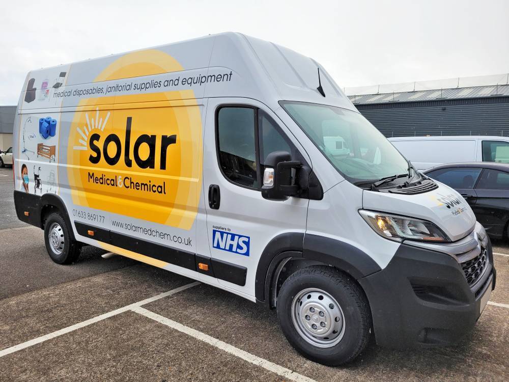 White Peugeot Boxer van with company branded partial vehicle livery.