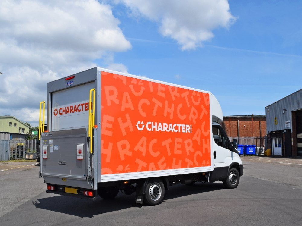 Orange Character.com company branded partial vehicle wrap on Iveco Daily Box van.