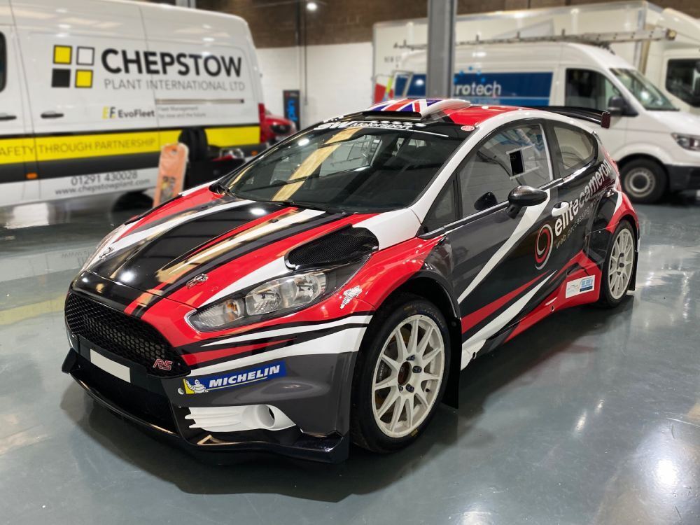 Ford Fiesta R5 company car with commercial livery.