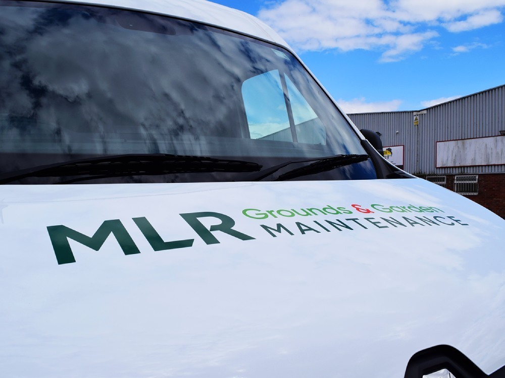 Branded vehicle vinyl graphics on bonnet of a white Renault Master van.