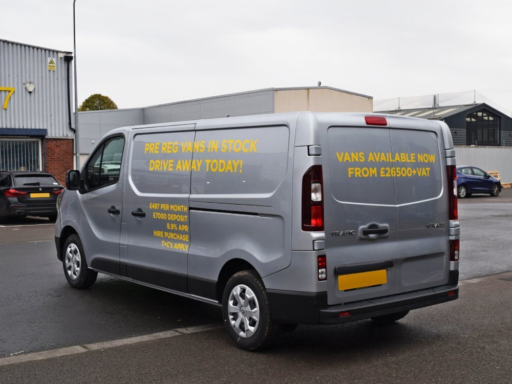 Yellow vinyl graphics on silver Renault Trafic company van.