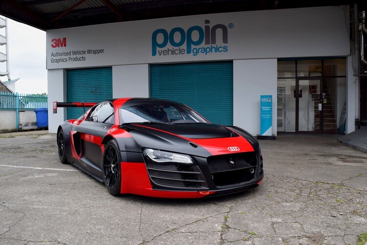 Red and black motorsport wrap on an Audi R8 LMS outside Popin in Cardiff.