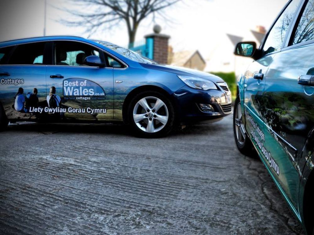 Branded vehicle wraps on a fleet of company cars.