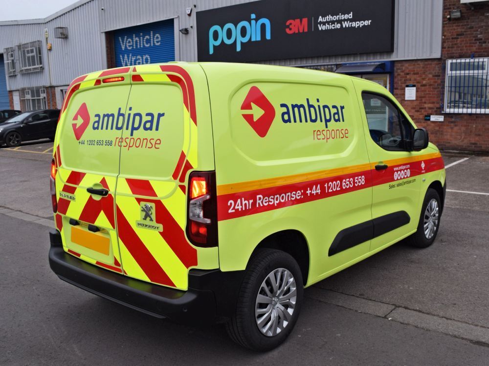 Bright fluorescent yellow Ambipar van wrap with chevrons on Peugeot Partner company vehicle.
