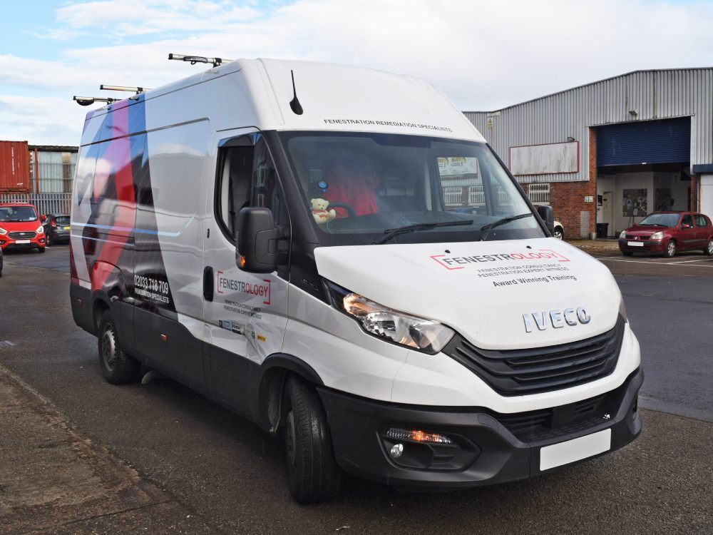 Company branded vehicle vinyl graphics on a white Iveco Daily van.