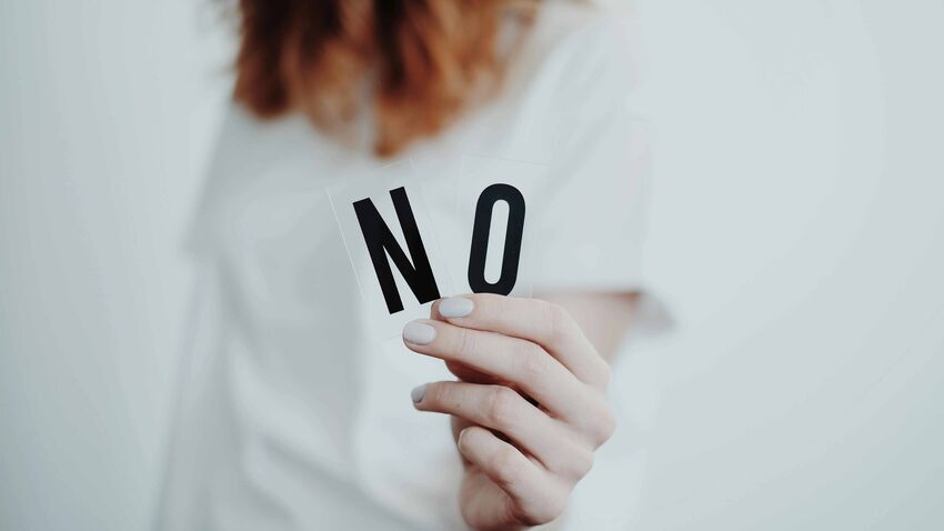 Woman holding the word no