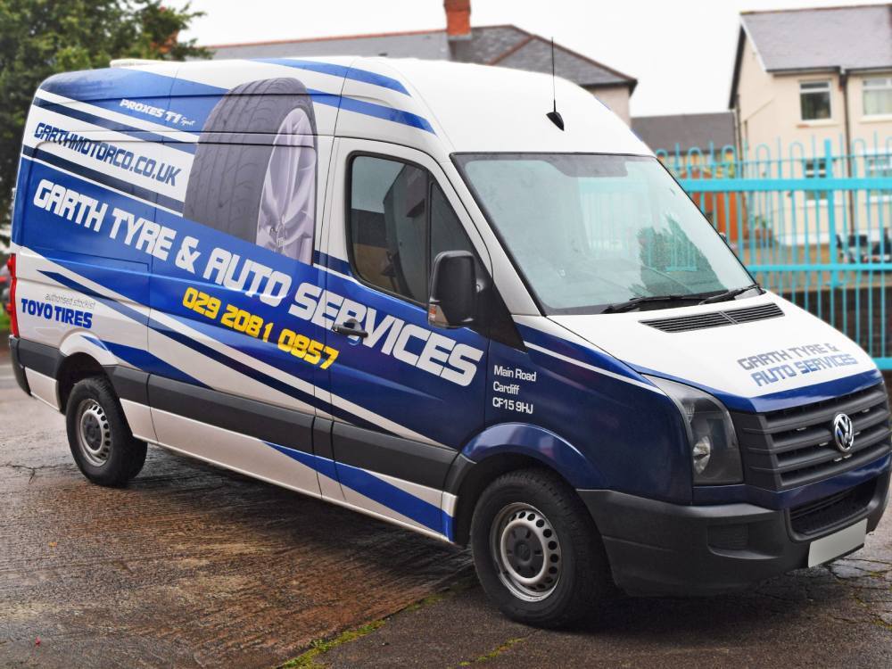 Blue and white vehicle wrap on company branded Volkswagen Crafter van.