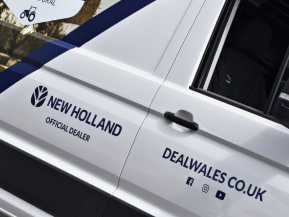 Vinyl graphics on a white company MAN TGE van.