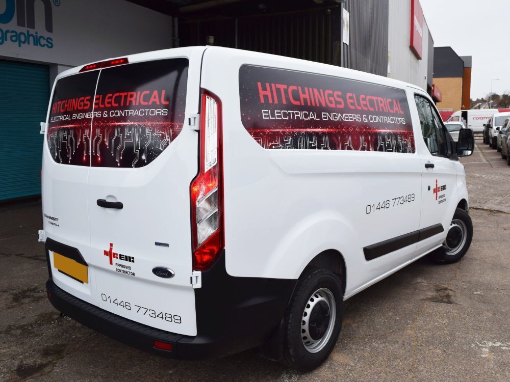 Branded infilled panel graphics on white company Ford Transit Custom van.