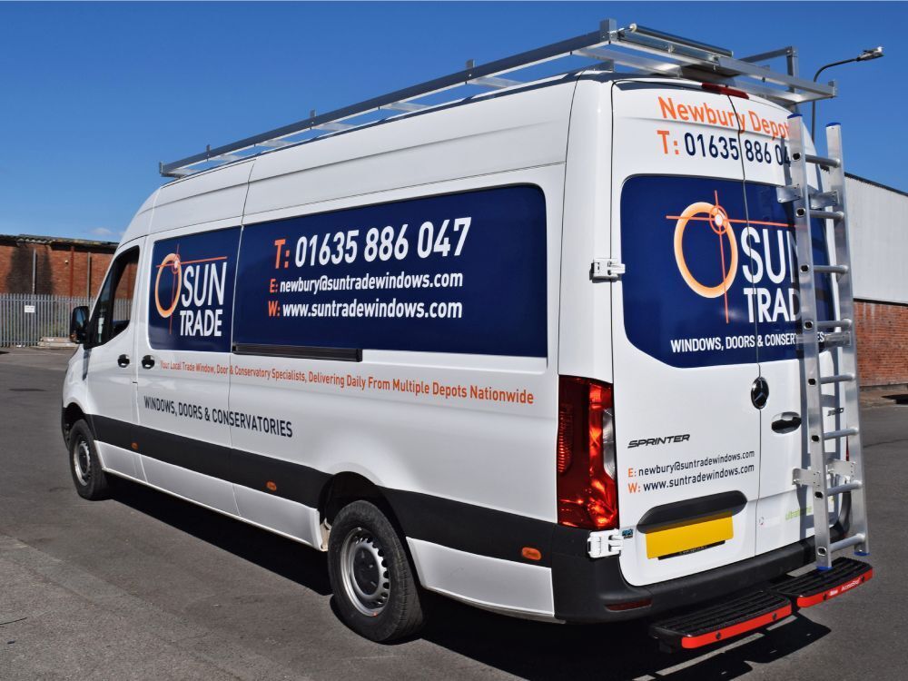 Branded infilled panel graphics on a white company Mercedes Sprinter van.