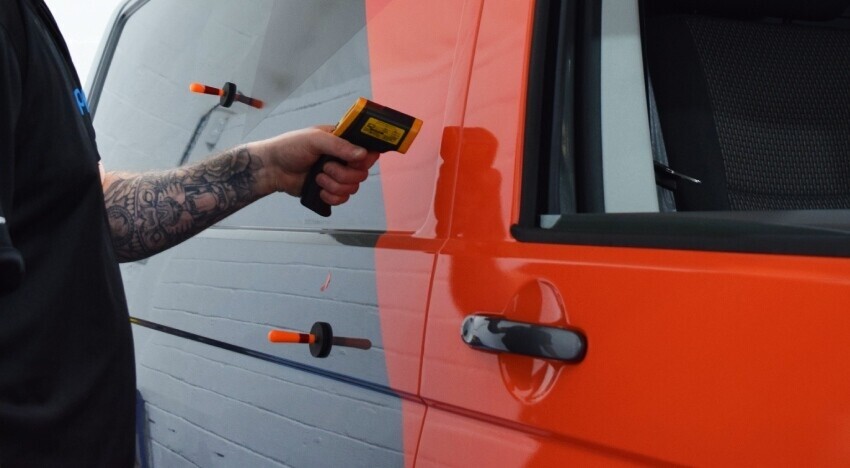 Vehicle wrap being installed onto a company Volkswagen van.