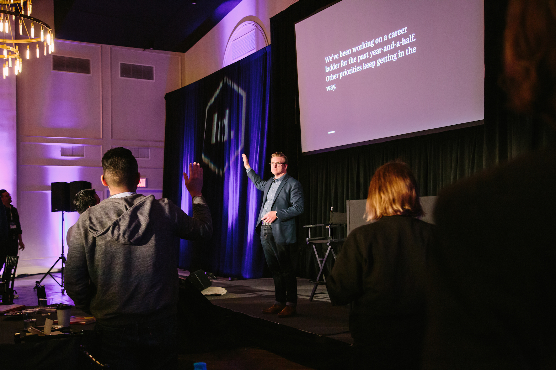 Todd Zaki Warfel stirring up some honest moments on stage at Leading Design New York where audience are raising their hands