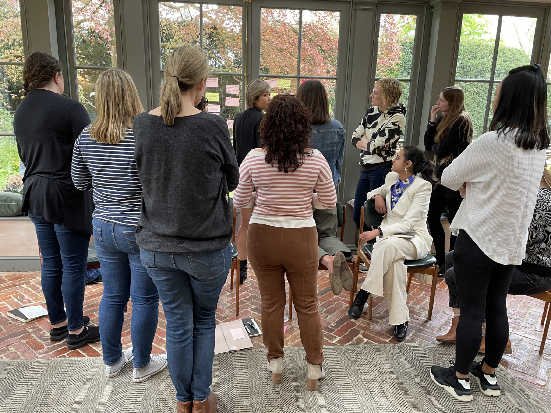 The group gathered round a board, deep in discussion.