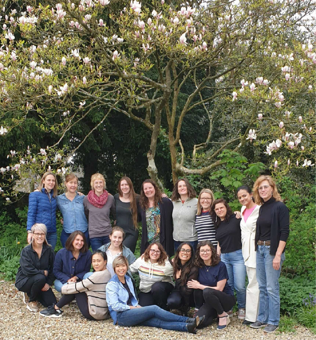 Happy-looking women gathered outdoors for a group photo.