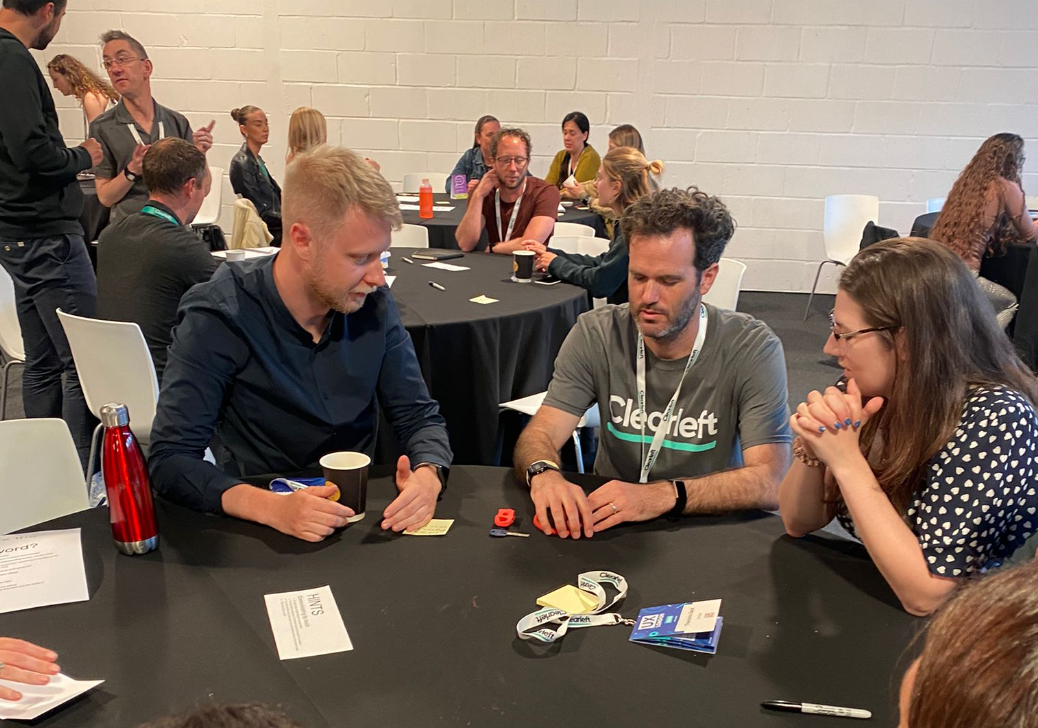 Workshop attendees gathered round tables mid-exercise.