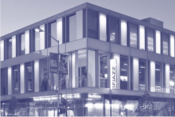 Exterior of the SF Jazz Center in San Francisco, a modern angular building with tall windows.