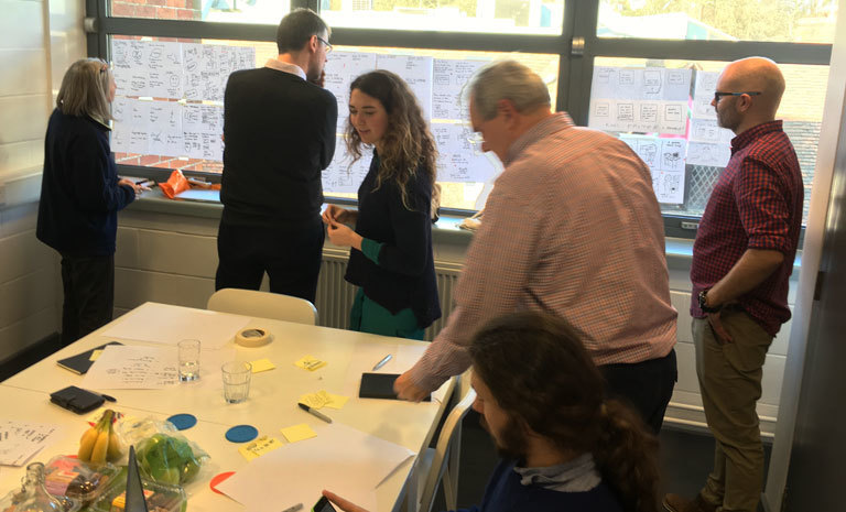 A group of people reviewing different design ideas
