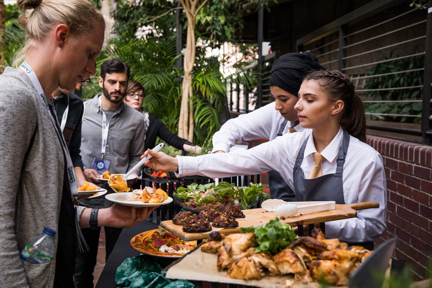 Attendees getting delicious food from the attentive staff.