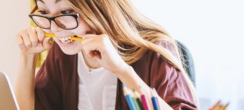 A person biting a pencil.