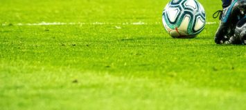 A football ball on the grass.