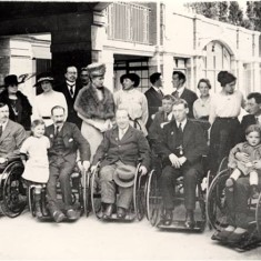 Visit of Queen Mary and Princess Mary to War Seal Mansions, with a group of ex-servicemen in wheelchairs, 5 Jun 1919. | Hammersmith and Fulham Archives