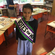 A pupil wears a Votes for Women sash | Westminster Archives