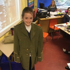 A pupil wears a military jacket replica from a soldier's uniform during WW1 | Westminster Archives