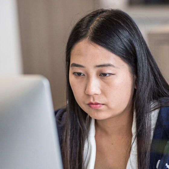 Photo of Thanawan working in the office