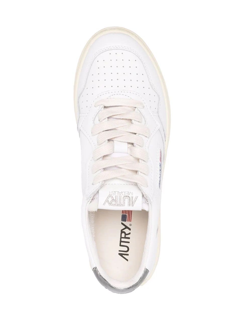 Women's Autry Sneakers  Stylish leather Autry sneakers with logo patches. Lace-up fastening and flat sole. White & silver.