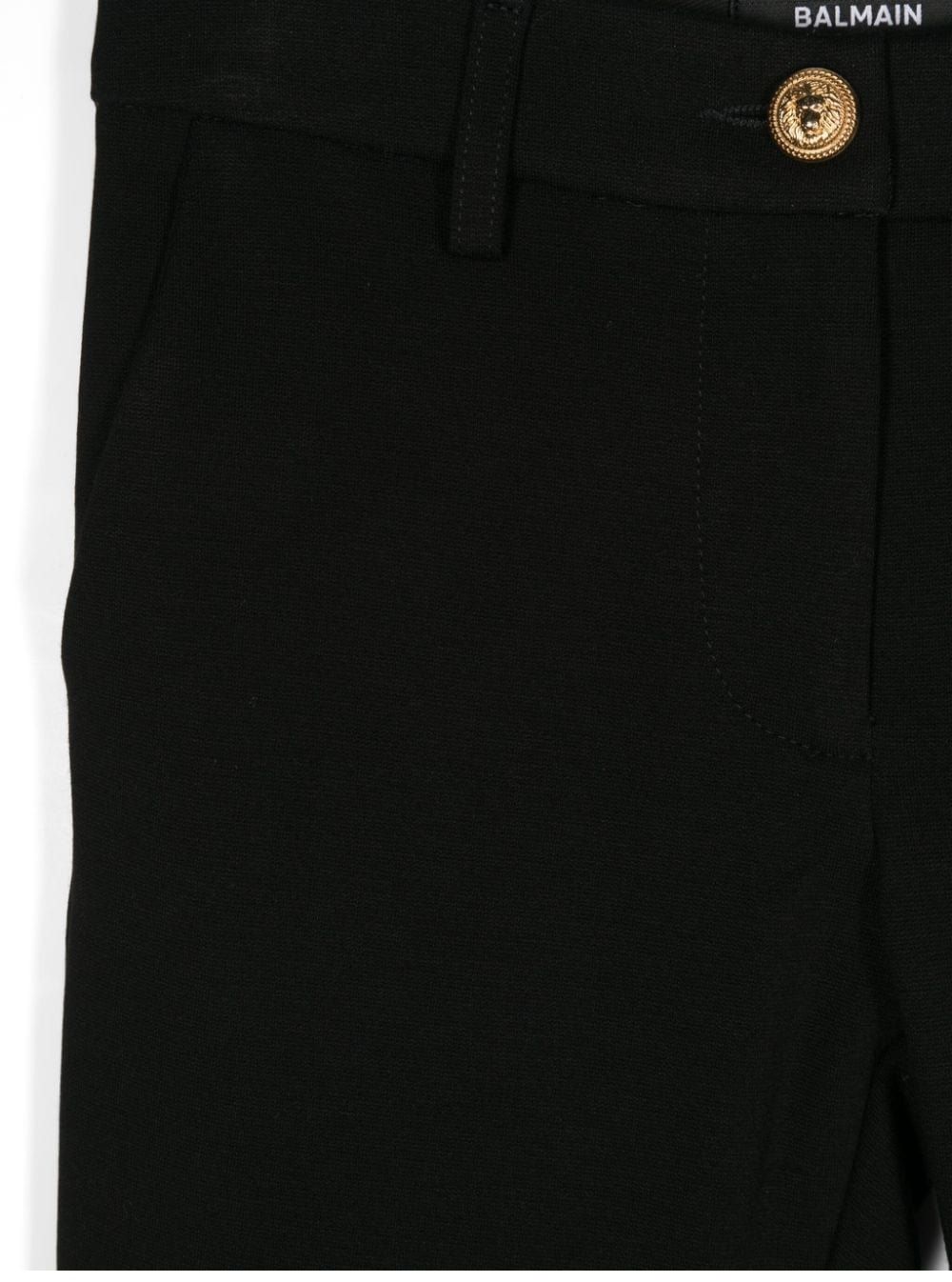 BALMAIN KIDS Girl's Pants Stylish and comfortable knit trousers for girls from BALMAIN KIDS. Made with 71% viscose, 24% polyamide, and 5% elastane for the FW24 season. Perfect for any occasion. Shop now!