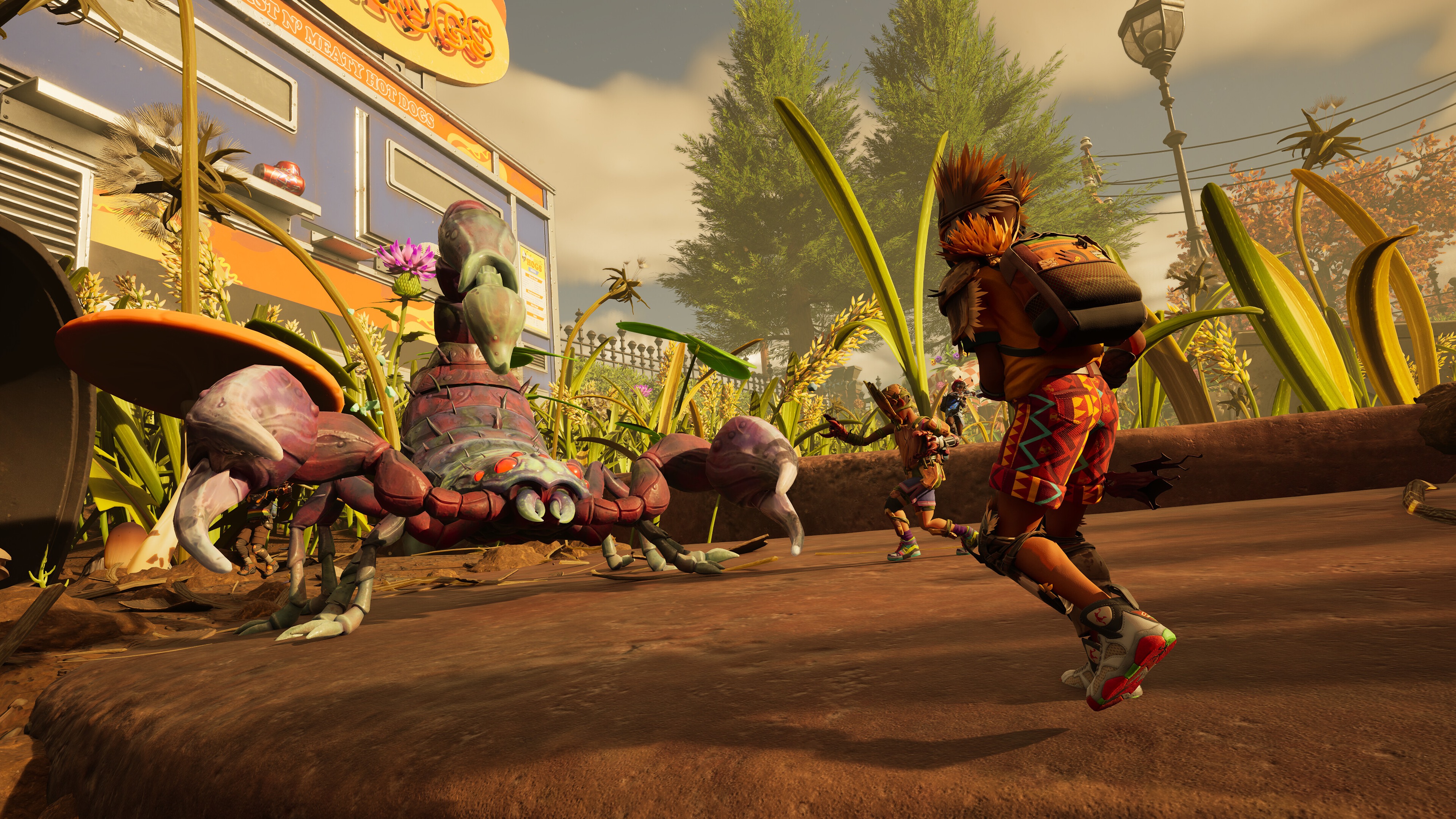 Promotional screenshot of players fighting a scorpion in Grounded 2