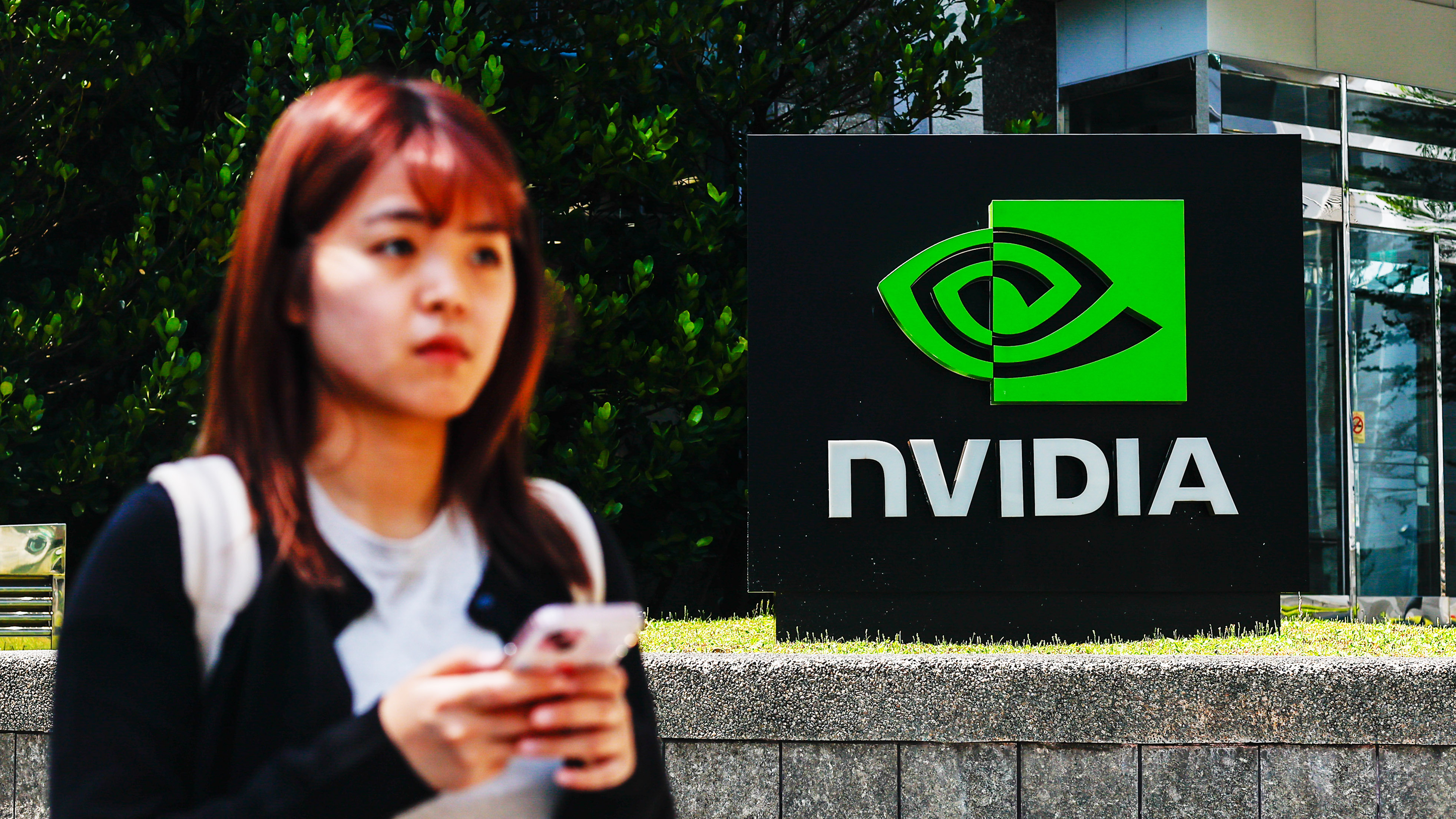 TAIPEI, TAIWAN - APRIL 16: The logo of NVIDIA, an American tech company which designs and supplies GPUs, APIs, and Artificial Intelligence (AI) software and hardware, in Taipei, Taiwan, on April 16, 2025. The United States President Donald Trump's administration has confirmed that tariffs on semiconductors and some other technology products will 'take place in the very near future'. With tariffs and export restrictions expected to be implemented by the American government, electronic products such as iPhone, smartphones, tablet, computer and other digital devices requiring advanced microchips, as well as such global supply chain are likely to be affected. (Photo by Daniel Ceng/Anadolu via Getty Images)