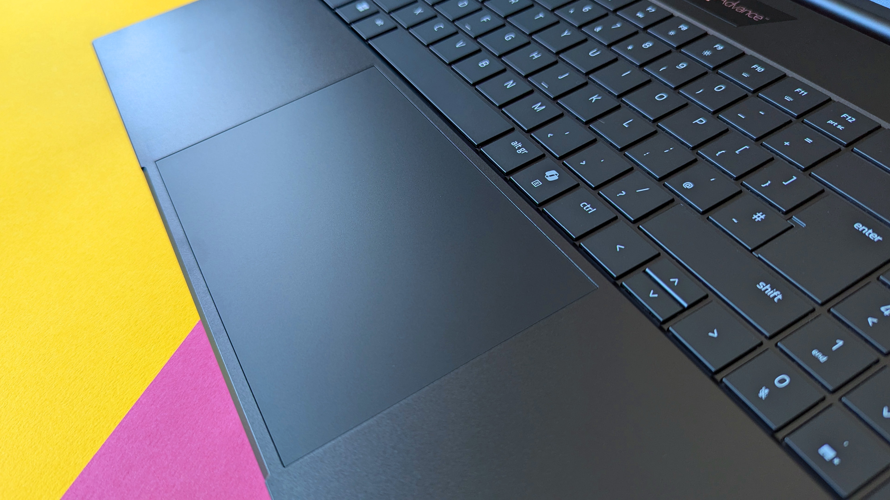 Razer Blade 18 (2025) игровой ноутбук на розовом и желтом фоне.