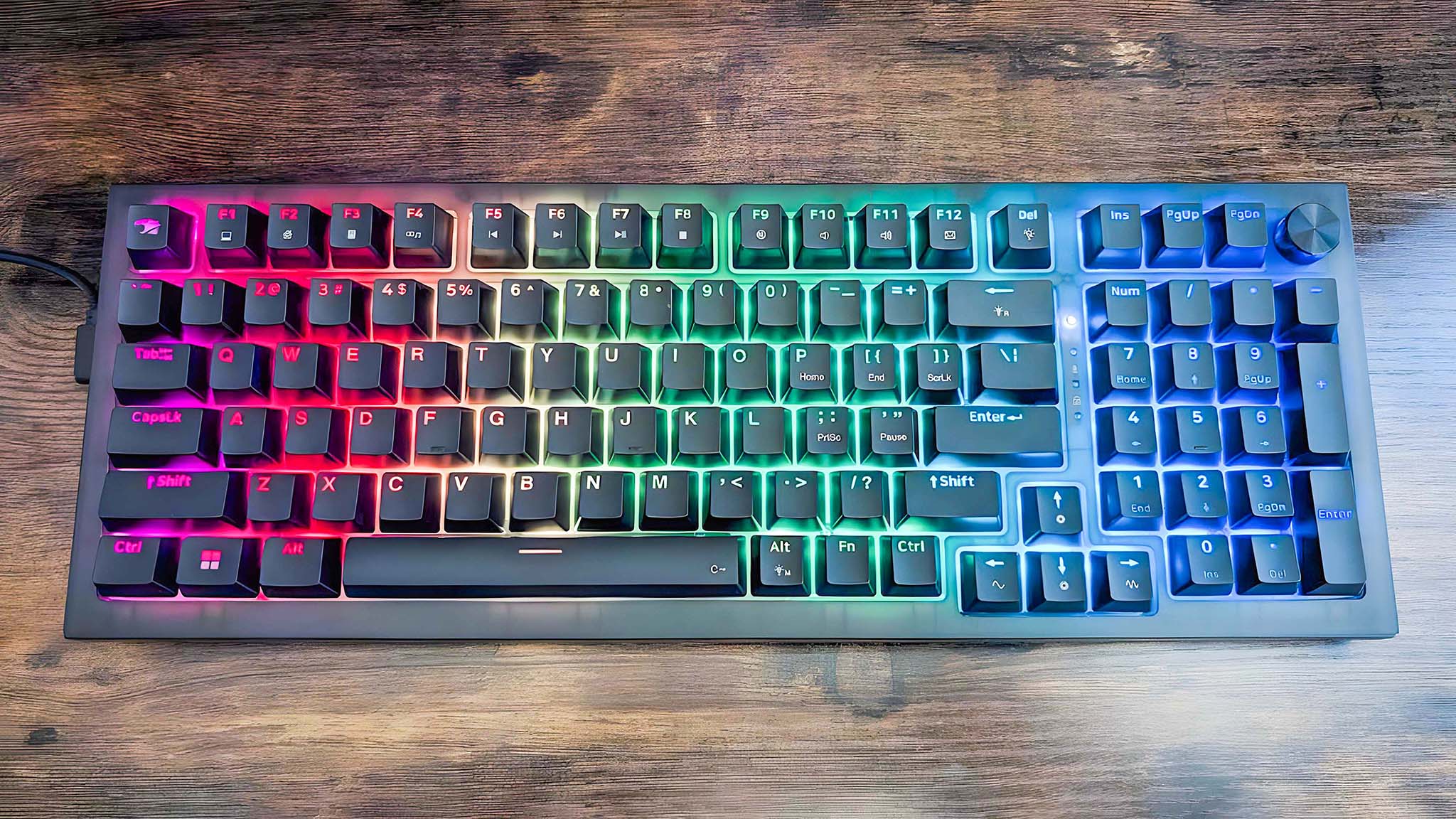 A top-down view of the iBuyPower MK9 Pro RGB Mechanical Keyboard with rainbow RGB turned on.
