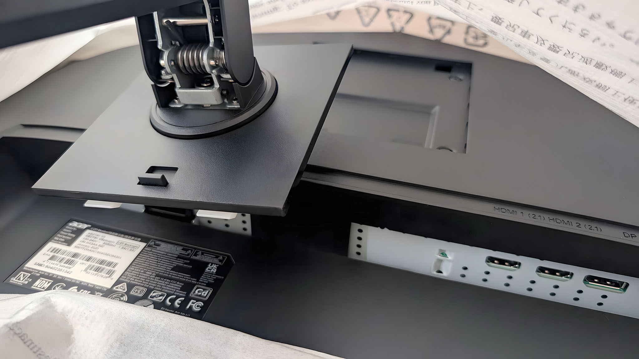 The Acer Predator XB273K's stand being pressed into the back of the monitor.
