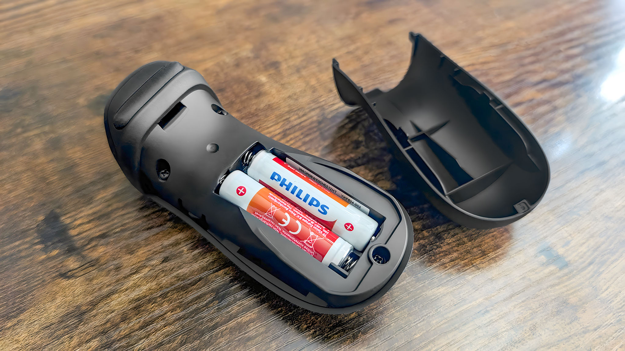 The Acer Predator XB273K's remote open to show the two AA batteries inside.