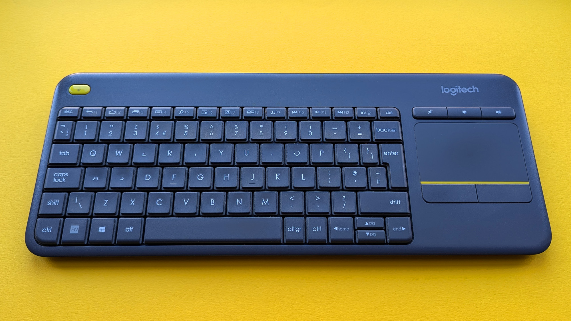 Closeup of Logitech K400 Plus wireless keyboard showing worn keys and buttons