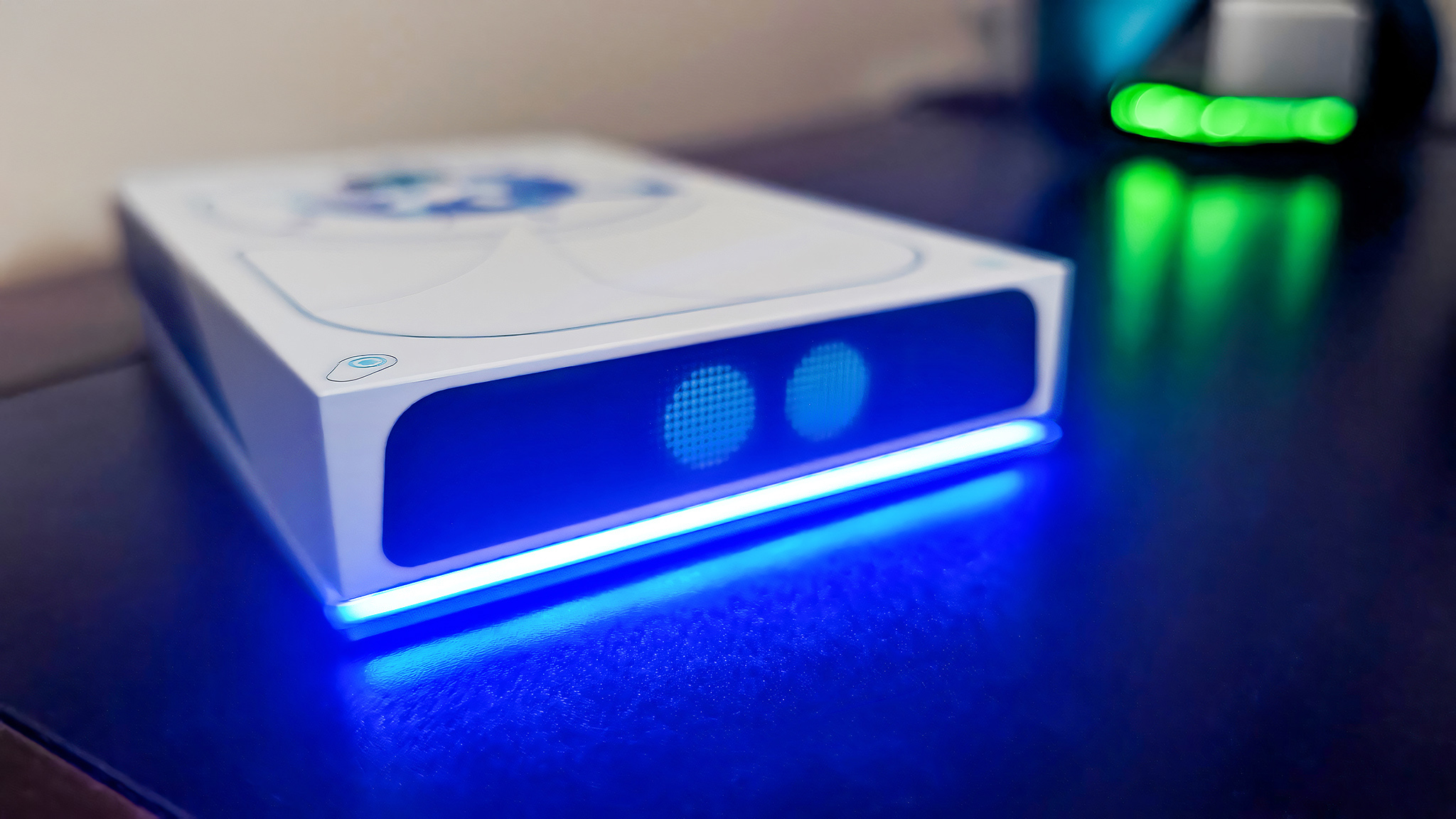 Seagate Astro Bot Limited Edition Game Drive sitting on a desk with a blue light glowing along its bottom.